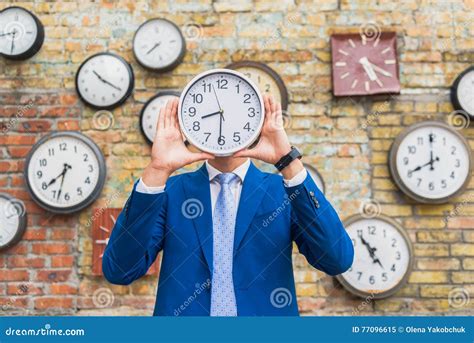 Man In Suit Standing Near Wall With Clocks Stock Image Image Of
