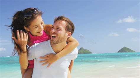 Beach Couple Having Fun Happy Running Out Of Water After Bathing And