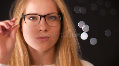 Relaxed Blonde Caucasian Girl In Glasses With Smart Look Touching Her Glasses Confidently