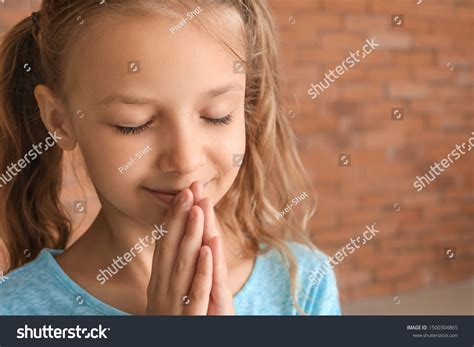 Cute Little Girl Praying Against Brick Stock Photo 1500304865