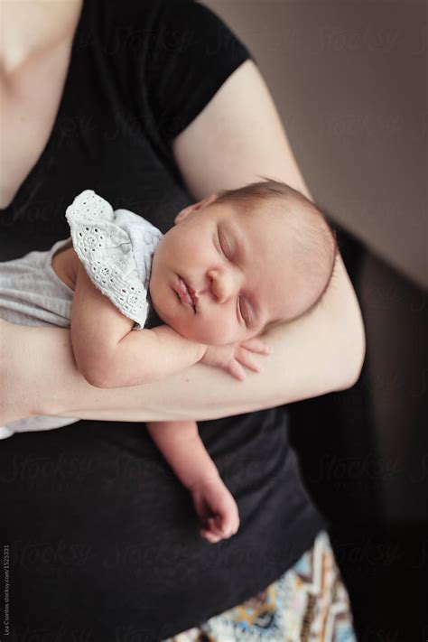 Beautiful Newborn Baby Girl Sleeping On Her Mothers Am By Stocksy