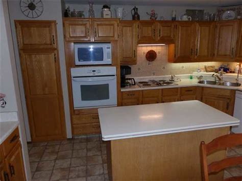 Cabinets and doors are custom made and in very good condition structurally, but the color and finish of the doors quite ugly. Buying a new house with an old, ugly kitchen?
