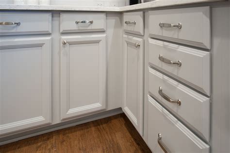 Refinished Cabinets In A Light Gray With New Silver Hardware