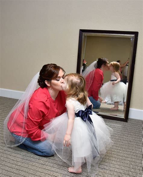 Bride Kissing Flower Girl In White While Getting Ready For Wedding