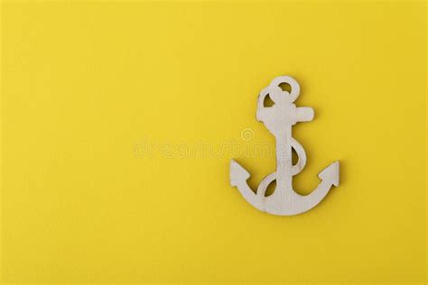 Wooden Anchor On Yellow Background Concept Of Sea Cruises Stock Photo