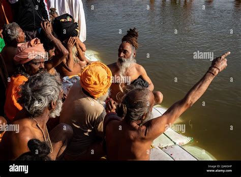Naga Sadhus Wait For Their Moment To Bathe In The Holy Waters Of The Ganges River During The
