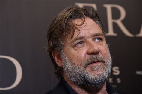 Russell Crowe Caught With His Hand Down The Back Of His Pant