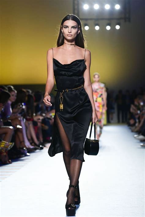 A Model Walks Down The Runway In A Black Dress