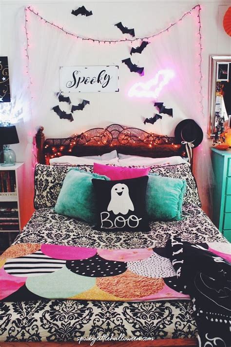 A Bed Room With A Neatly Made Bed And Halloween Decorations