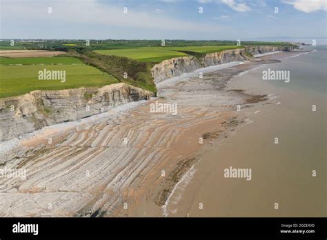 Aerial View Of Sea Cliffs Rock Formations And A Sandy Beach