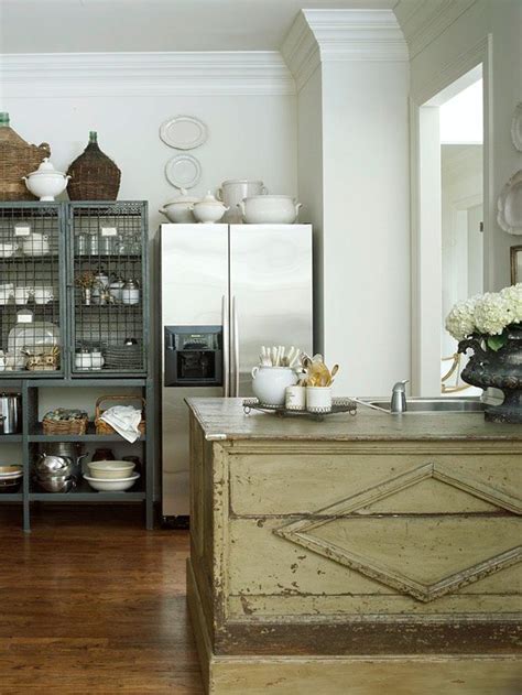 In a french country kitchen, group colorful pots and plates, some reclining and some standing, with similar type objects on an open shelf or above kitchen cabinets. The Tricks You Need To Know For Decorating Above Cabinets ...