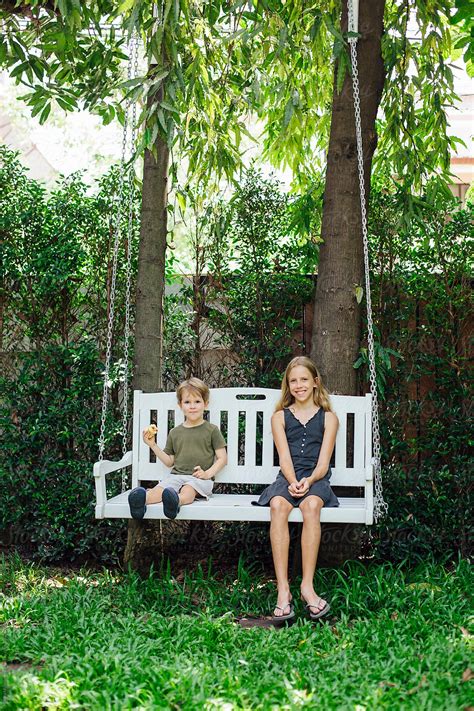 Brother And Sister On Swing By Stocksy Contributor Marko Stocksy
