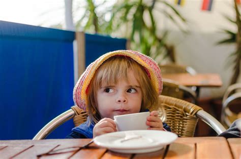 Girl Holding Coffee Cup While Sitting In Cafe ID 90748617