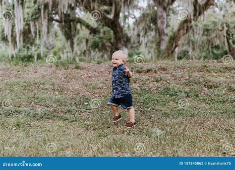 Adorably Happy And Cute Little Caucasian Toddler Baby Boy With Long
