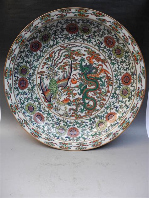 They're cultural symbols of china. A Superb Doucai "Dragon and Phoenix" Dish