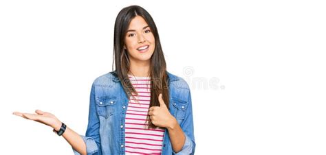 Young Brunette Woman Wearing Casual Clothes Showing Palm Hand And Doing Ok Gesture With Thumbs