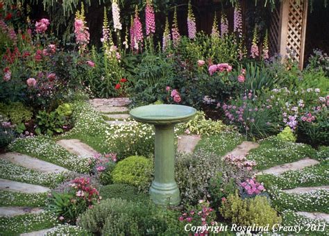 The right fence for your garden can enhance its natural beauty, while serving the useful fu. stone path with bird bath | Outdoor herb garden, Herb ...