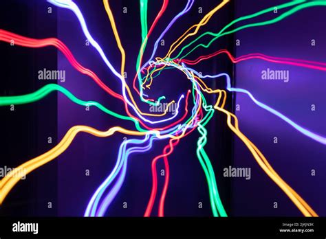 A Spiral Of Colorful Neon Light Waves For Wallpapers Stock Photo Alamy