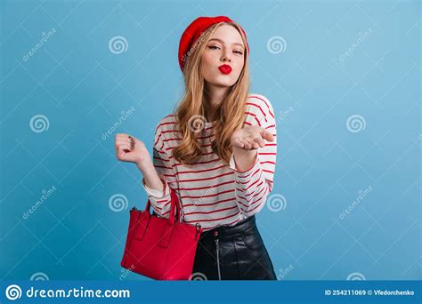 Romantic French Girl Looking At Camera Stylish Woman In Beret Holding Red Handbag Stock Image