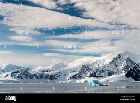 Antarctica Blue Sky And Clouds Abaove The Dramatic Mountainous