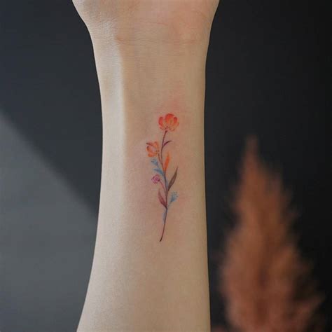 Small Watercolor Flower Tattoo On The Wrist