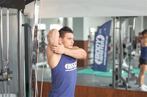 Standing Low Pulley One Arm Triceps Extension How To Do It Video Of Performing Technique