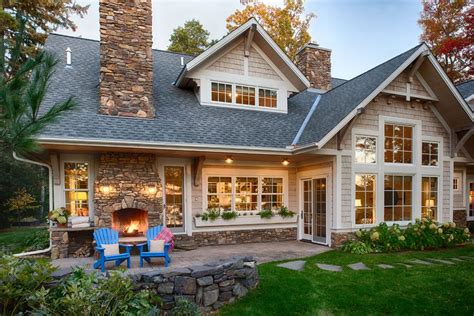 A House With Two Chairs And A Fire Place In Front Of The Porch