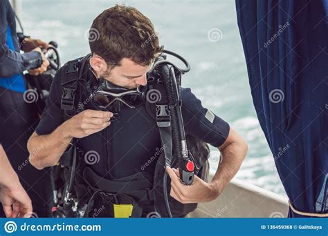Diver Prepares His Equipment For Diving In The Sea Stock Photo Image