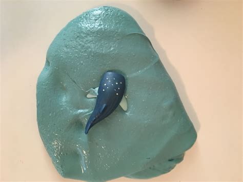 There Is A Blue Cake That Looks Like A Whale On Its Back End