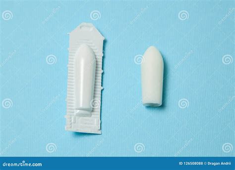 suppository for anal or vaginal use on a blue background candles for treatment of hemorrhoids
