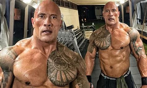 dwayne the rock johnson goes shirtless as he shows off his bulging muscles