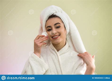 Beautiful Young Woman In A Bathrobe And Towel After Shower Is Doing Herself A Makeover Apply