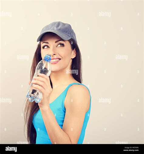 Beautiful Happy Sporty Thinking Woman Drinking Water From Bottle After