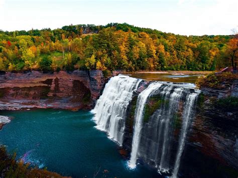 Aerial View Of Green Trees Covered Forest With Waterfall Pouring On