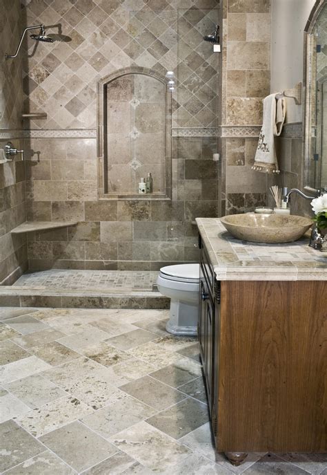 Stone bathroom tile is durable and versatile. This driftwood travertine was installed in 2008 and still ...