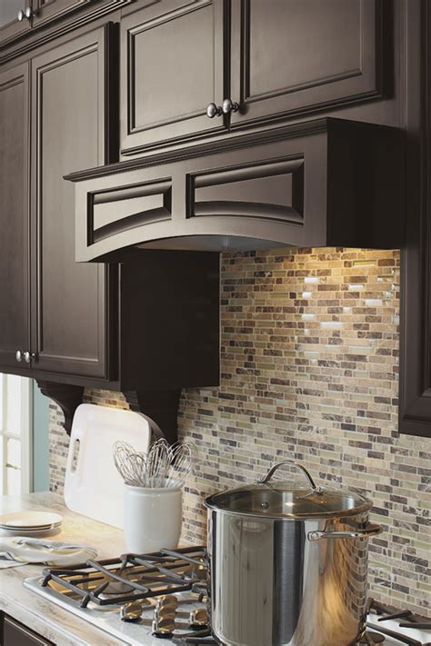 The most common wood canopy bed material is cotton. Arched Wood Hood Canopy- Diamond Cabinetry