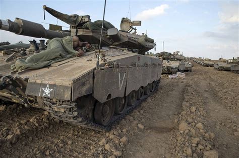 Israeli Tanks Dig In At Gaza Frontier As Palestinian Toll Tops 300