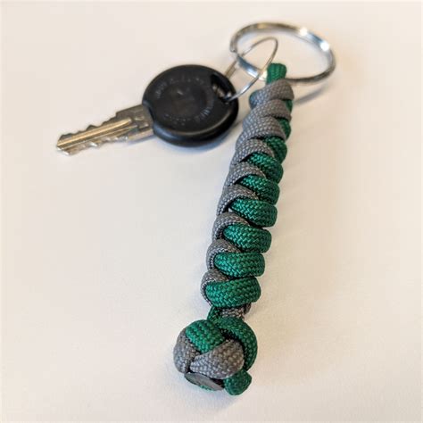 Start with two 24″ pieces of paracord; Snake Knot Keychain | Paracord projects diy, Knot keychain, Paracord