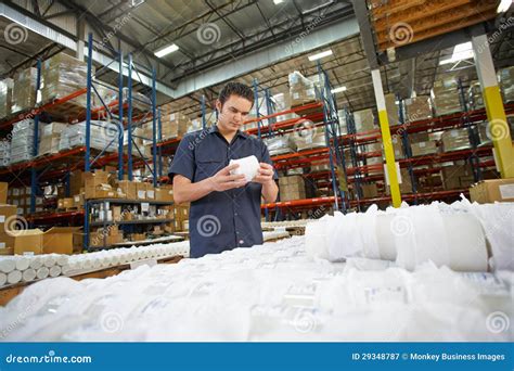 Factory Worker Checking Goods On Production Line Royalty Free Stock