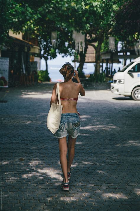 Back View Of Young Woman Walking To The Beach By Stocksy Contributor Andrey Pavlov Stocksy