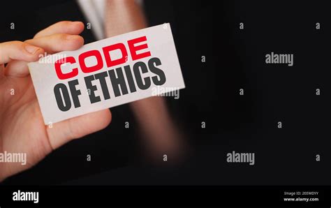 Businessman Shows A Card With Text Code Of Ethics Stock Photo Alamy