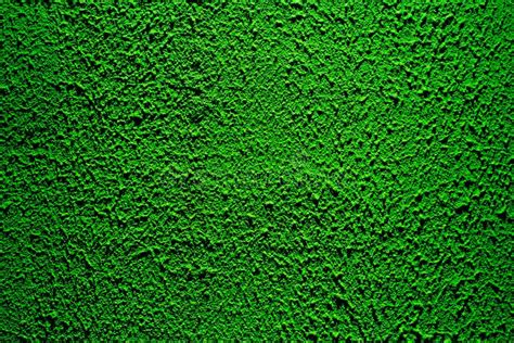 Brightly Lit Surface Covered With Bright Green Plaster Stock Photo
