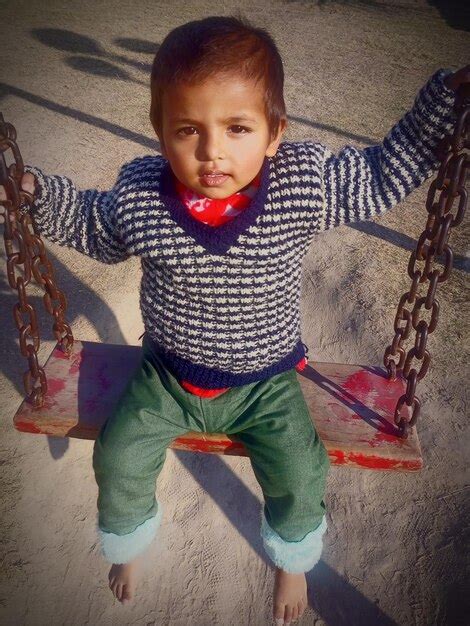 Premium Photo Cute Desi Baby Girl Enjoying Swing In A Park