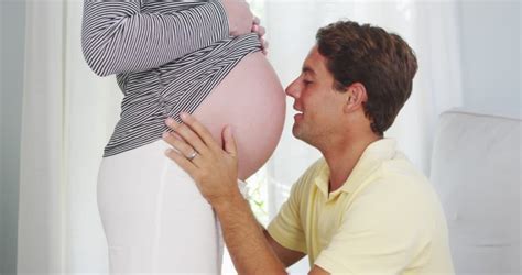 That is how far you should stick your tongue out in a kiss. Excited Husband Kissing Pregnant Womans Stock Footage ...