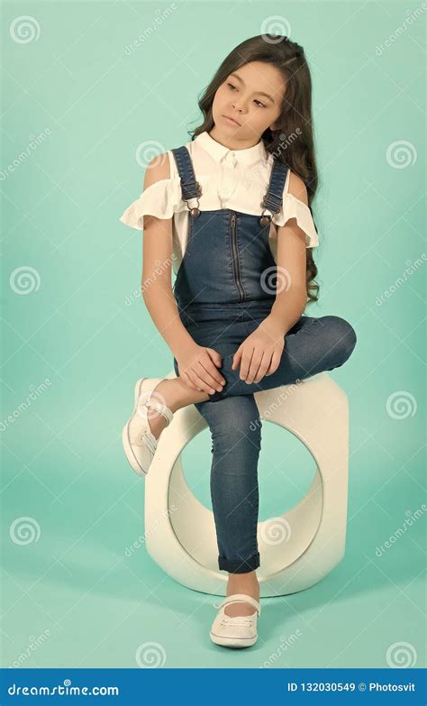 Kid In Jeans Overall Sit Leg Crossed On Chair Stock Image Image Of