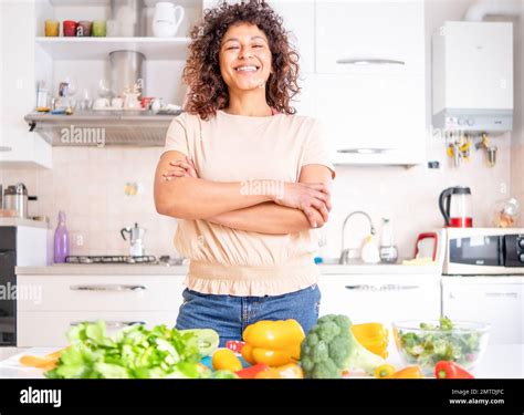 Cheerful Black Woman Cooking At Home Looking A The Camera Stock Photo Alamy