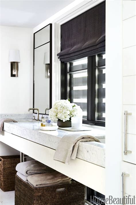 The light blue paint used for the upper wall is almost the same shade as the towels and the small bird cage used for decorating the white sink top and cabinets. 12 White Bathrooms For Every Luxury Bathroom Decor Style
