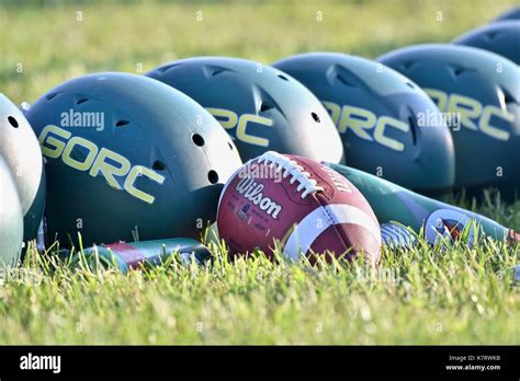 Wilson Football Laying Next To Row Of Football Helmets Stock Photo Alamy