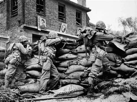 Us Marines Stand Behind A Sandbag Barricade During The Korean War