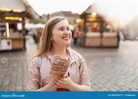 Smiling Modern Child At Fair In City Eating Trdelnik Stock Image